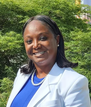 Dorothy Drain, DMD, in a white coat outdoors